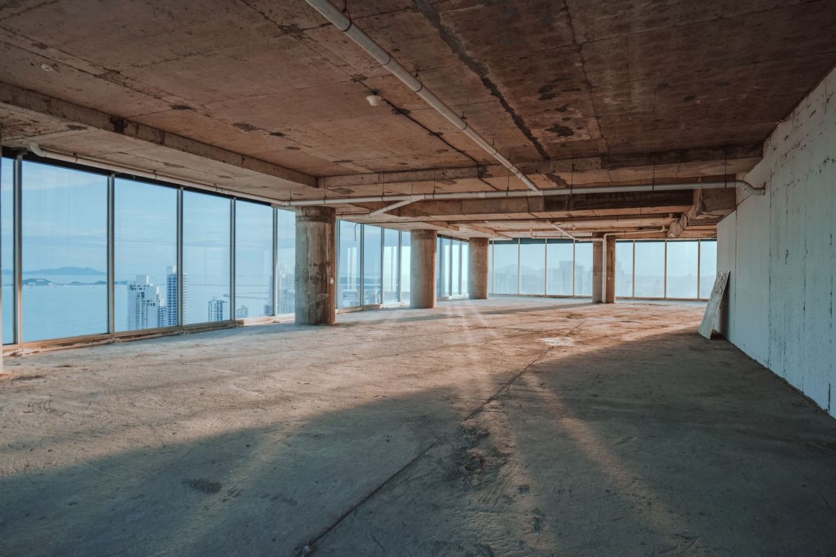 Open, unfinished office floor with floor-to-ceiling windows ready for buildout