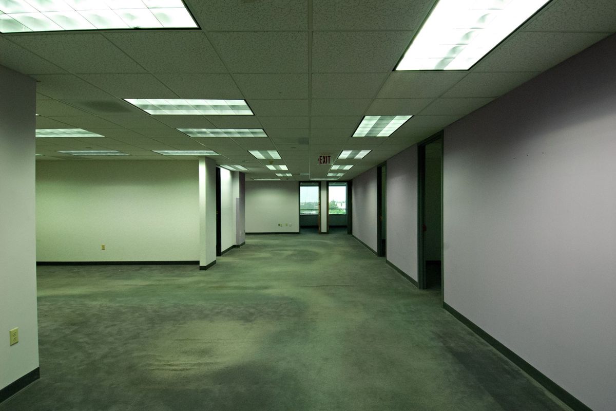 Empty finished office floor with drop ceilings and fluorescent lighting